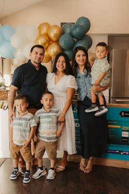 A young family celebrating with balloons in their new kitchen